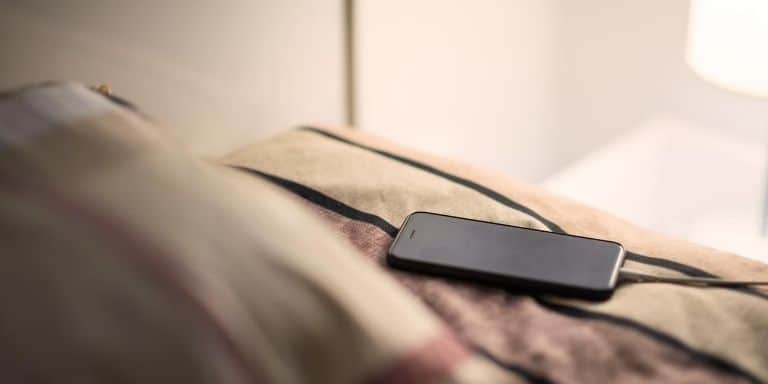 mobile phone charging by the bed