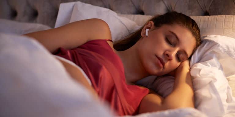 Woman sleeping with earbuds