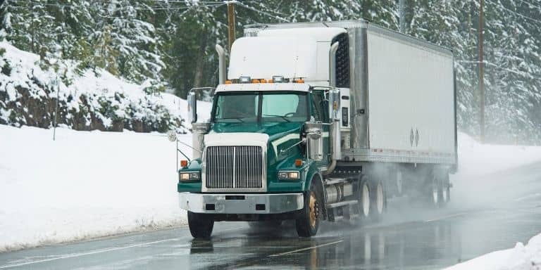 Semi-truck driving in winter condition