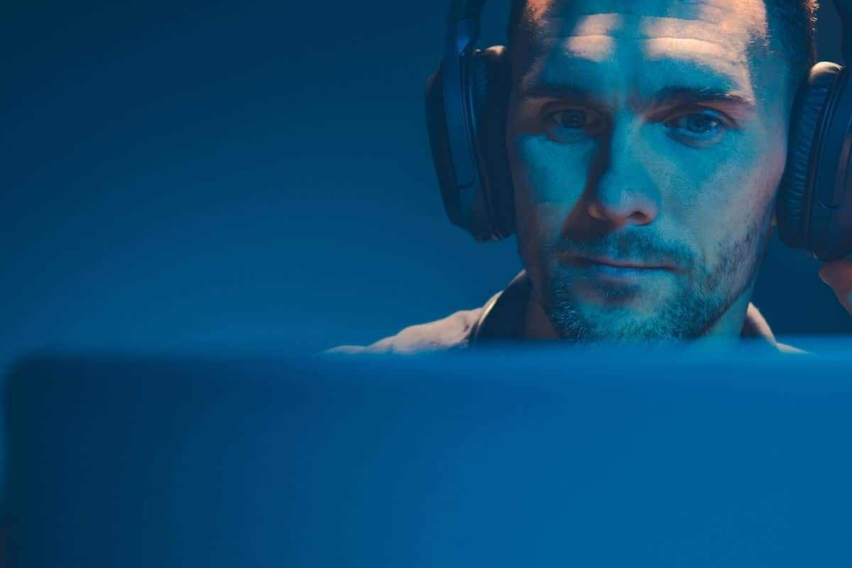 Man with headphones in front of PC