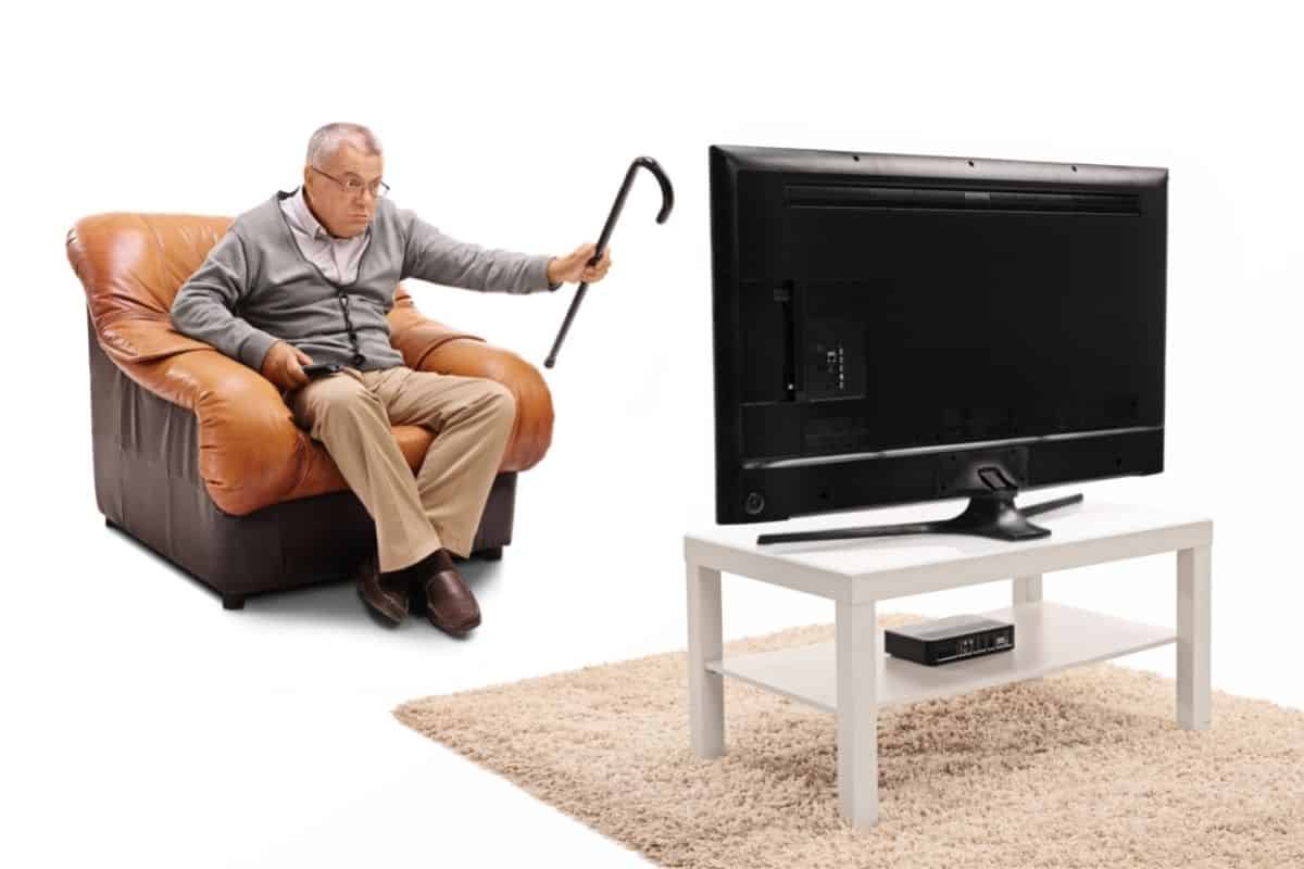 Old man annoyed with his TV