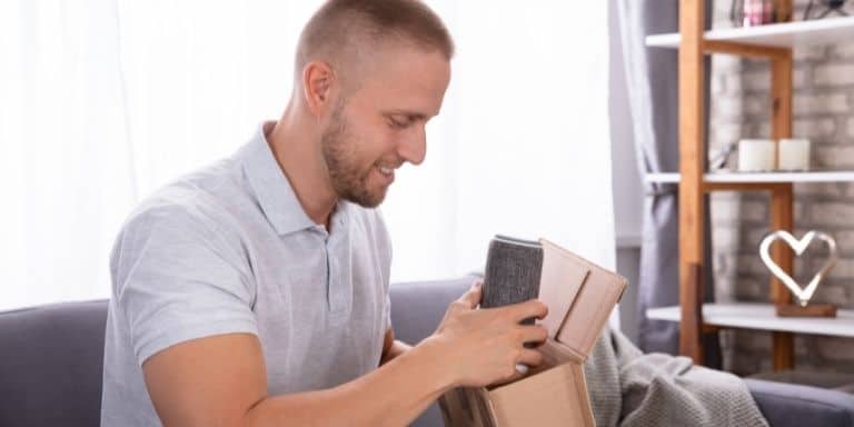 Man unpacking a wireless speaker